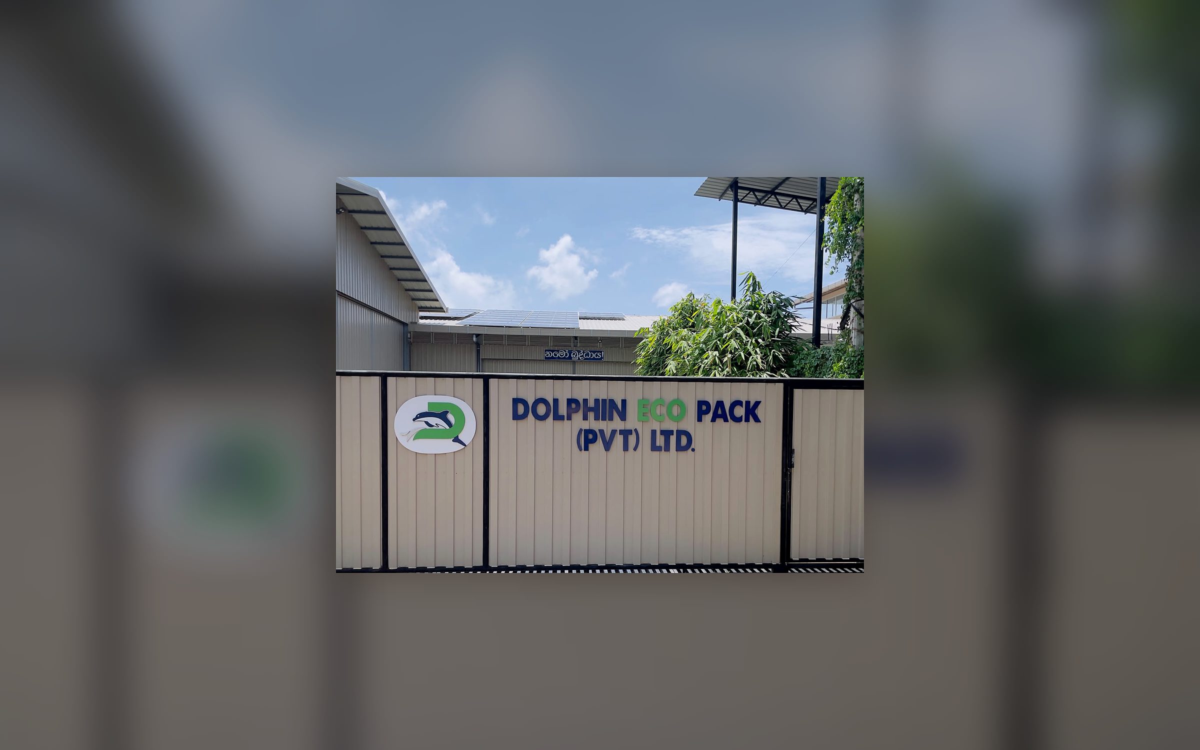 The entrance to the works at Kekanadura, with the Dolphin Eco Pack sign above the gate
