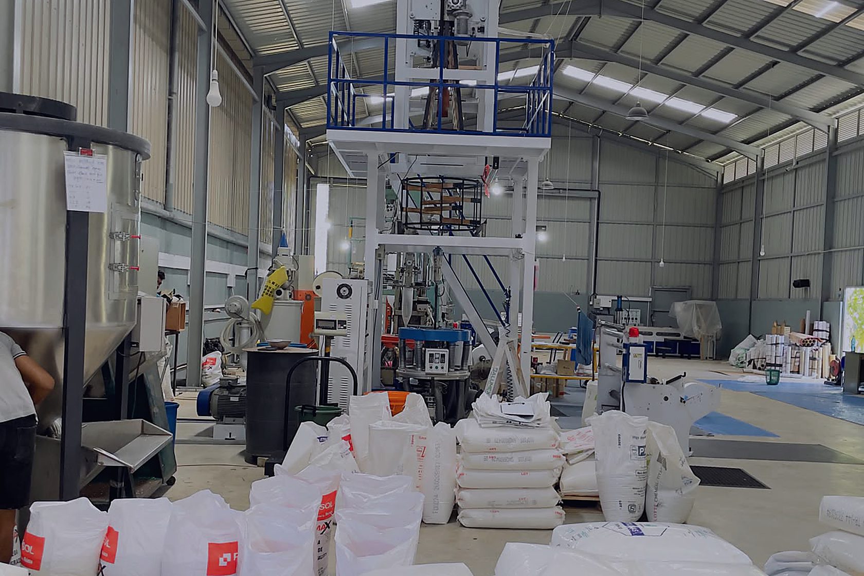 The extrusion hall, resin sacks stacked at the machines
