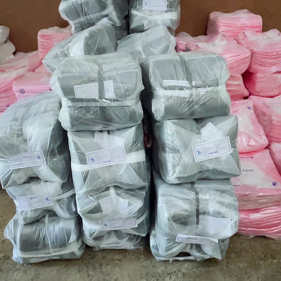 Bundles of grey and pink polythene film, bagged for despatch