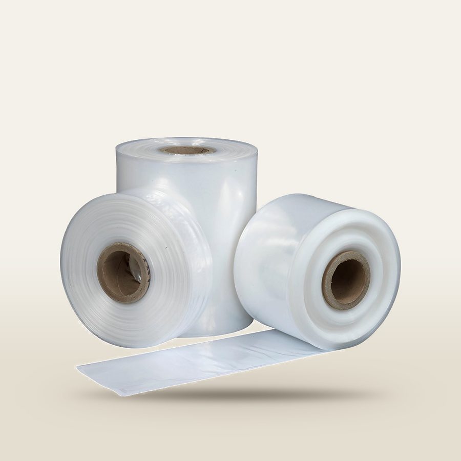 Rolls of clear polythene layflat tubing on cardboard cores, with a length unrolled in front